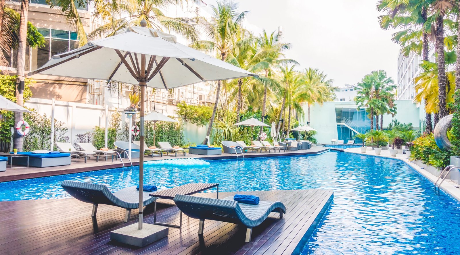 Umbrella pool and chair around beautiful luxury swimming pool in hotel resort - Vintage Light film Filter